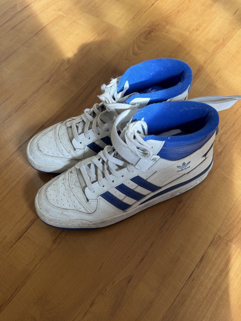 Adidas Forum Mid White Blue Sneakers (Category: Sneakers) located in Cavite. Submitted by devareaux (Listing ID 1424164668, Image 2). Description: - Adidas Forum Mid sneakers - White and blue colorway - Adidas logo on tongue and side - Strap closure - Blue accents on collar and stripes - Blue soles - Visible size tag - i rarely use it .