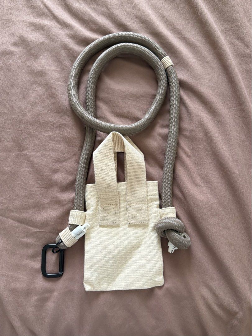 ATOZ Mini Chunky Bag (Off white) (Category: Luxury Bags & Wallets) located in Manila. Submitted by pnrzamora (Listing ID 1424211072, Image 2). Description: Minimalist canvas bag with rope strap. Features a flap and buckle closure. Adjustable strap. Neutral color. Bought in ATOZ for 1.2K Selling for PHP 500.
