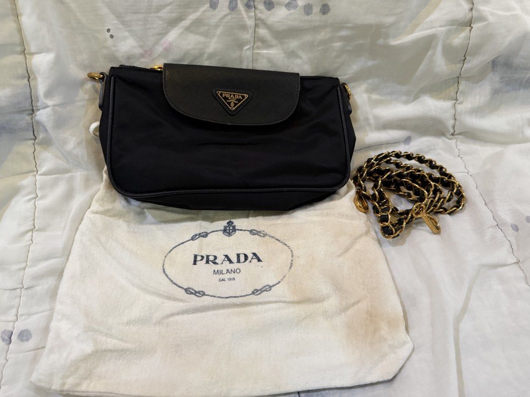 Authentic Prada Black Nylon Shoulder Bag (Category: Luxury Bags & Wallets) located in Paranaque City. Submitted by lovebrand (Listing ID 1424239685, Image 1). Description: - Authentic Prada shoulder bag - Black nylon material with Saffiano leather - Elegant gold chain strap - Features a black leather flap with the Prada logo - Secure zipper closure - Includes original dust bag.