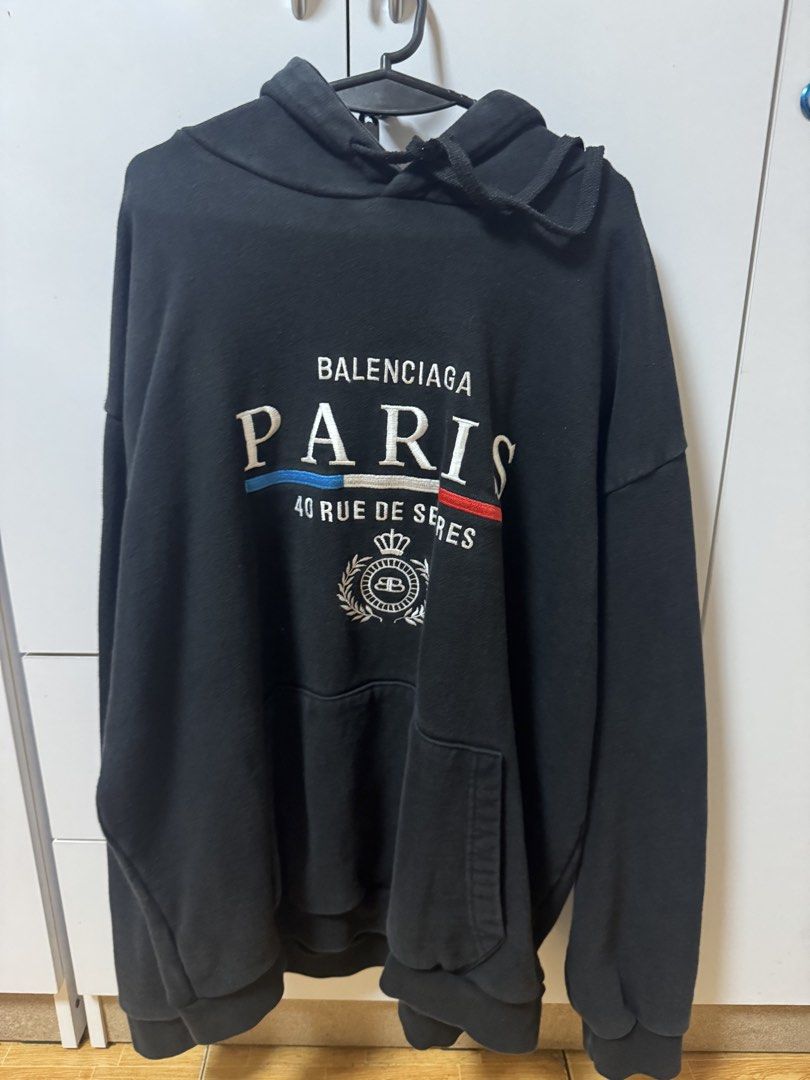 Balenciaga Paris Hoodie (Category: Hoodies) located in Manila. Submitted by quintessesommerset (Listing ID 1424221606, Image 1). Description: - Balenciaga Paris hoodie - Embroidered brand name and "PARIS" detail - "40 RUE DE SEVRES" inscription - Front pocket - Hood with drawstrings - Authentic Balenciaga label.