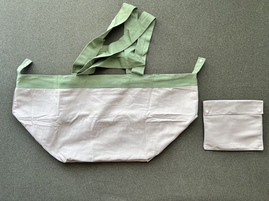 Beyond The Vines Reversible Tote Bag (Category: Tote Bags) located in Antipolo. Submitted by mitchdeclutters (Listing ID 1424167788, Image 3). Description: - Beyond The Vines tote bag - Unique design with front pocket - Color: Light pink body, green top and handles - Includes matching light grey pouch - Foldable and storable in pouch.