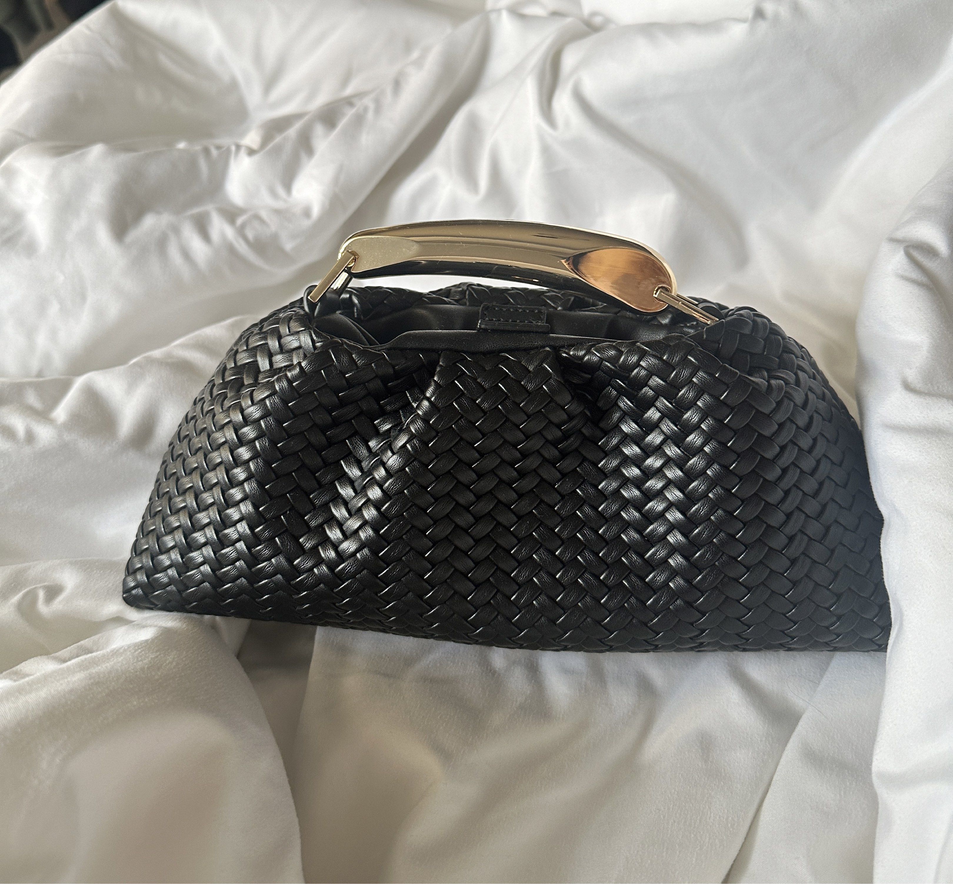 Black Woven Handbag with Gold Handle (Category: Shoulder Bags) located in Manila. Submitted by pck_____ (Listing ID 1424209211, Image 1). Description: - Black woven handbag - Stylish gold handle - Unique woven texture - Secure clasp closure - Clutch-style design - Perfect for essentials - Sleek and modern.