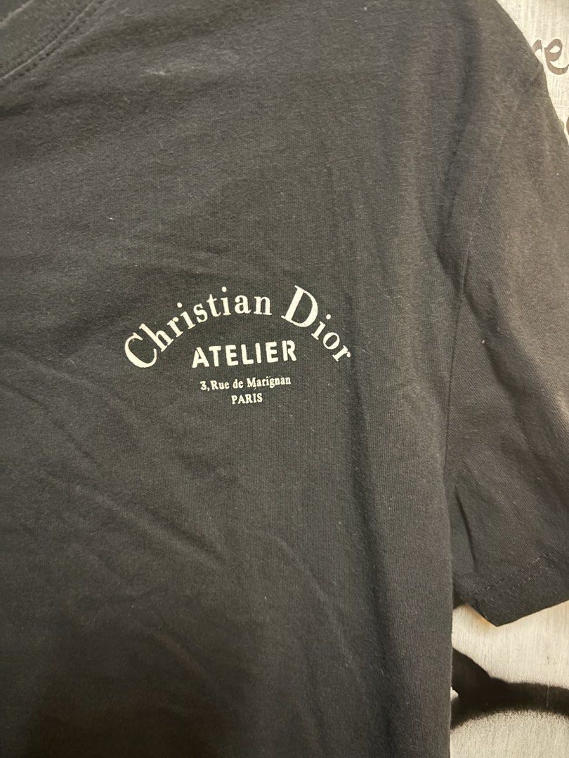 Christian Dior Atelier Black T-shirt (Category: Tshirts & Polo Shirts ) located in Quezon City. Submitted by tarphouse (Listing ID 1424324924, Image 3). Description: - Authentic Christian Dior Atelier T-shirt - Features the Christian Dior Atelier logo on the front - Back of shirt displays '3, Rue de Marignan PARIS' - Classic crew neck design - Short sleeves - Includes Christian Dior Paris tag.