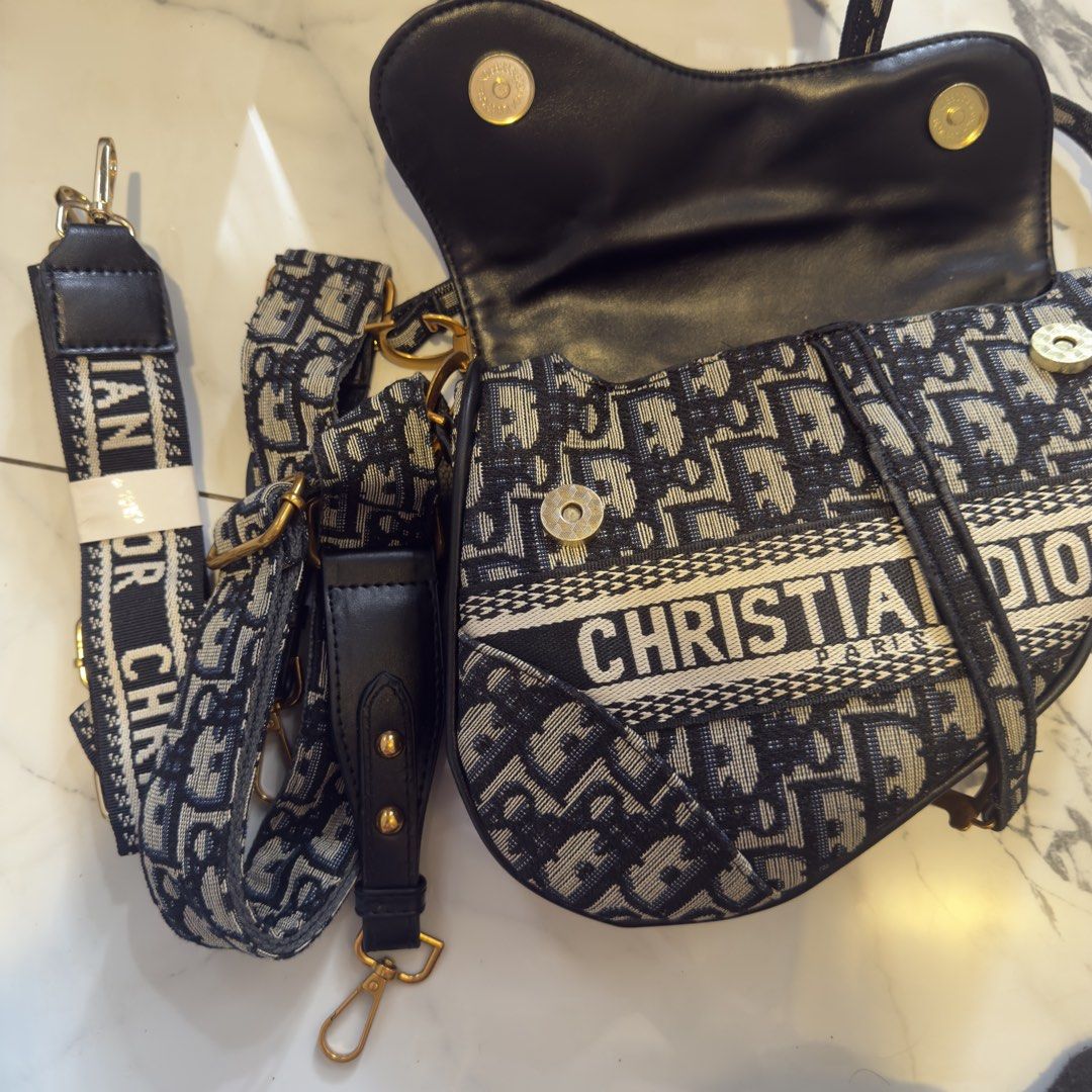 Christian Dior Saddle Bag Oblique (Category: Luxury Bags & Wallets) located in Manila. Submitted by rwymdfinds (Listing ID 1424169871, Image 2). Description: - Christian Dior Saddle Bag - Oblique canvas material - Iconic 'CD' logo - Detachable shoulder strap - Spacious interior compartment - Signature navy and white Dior print - Elegant gold-tone hardware.