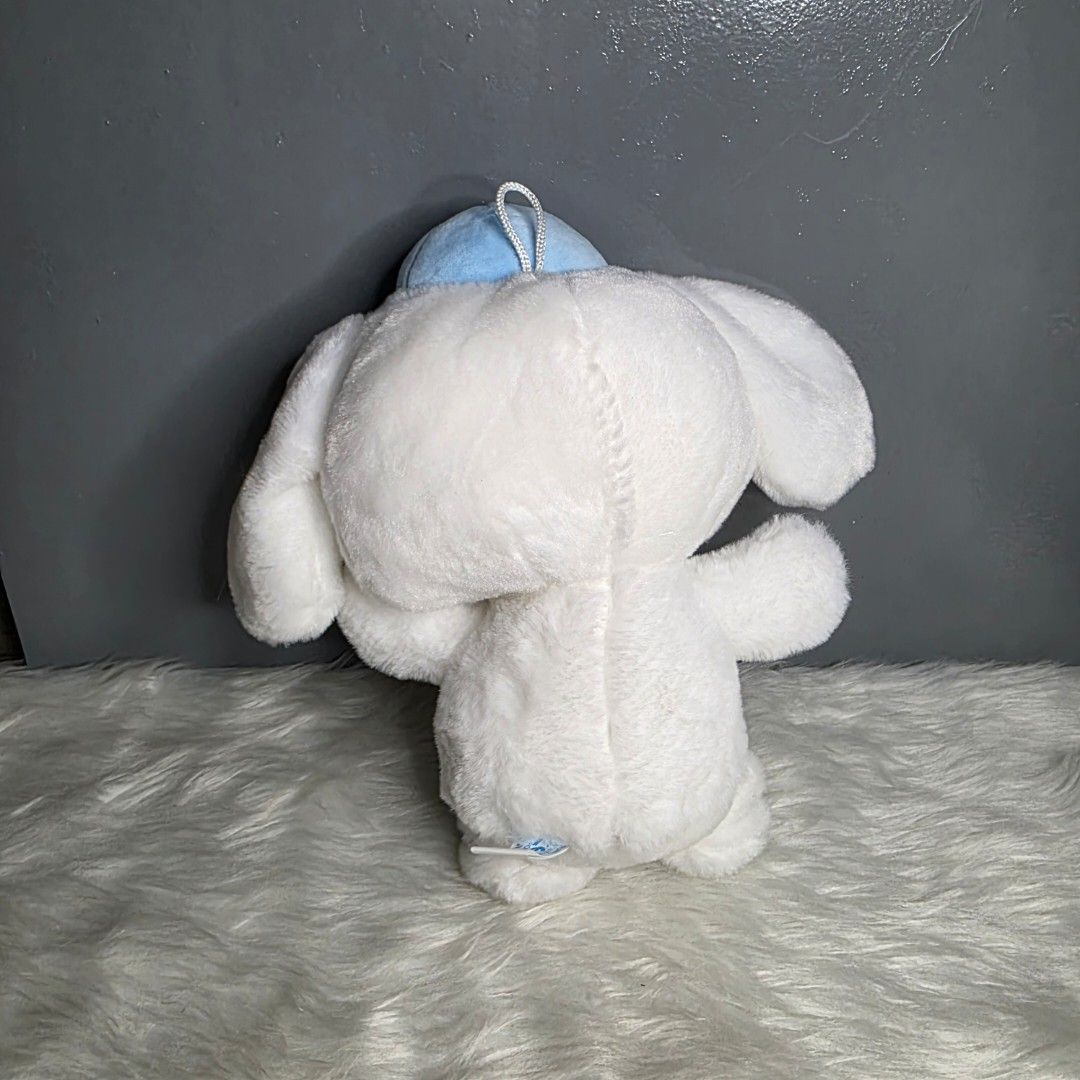 Cinnamoroll Plush Toy Claw Machine (Category: Plushies & Soft Toys) located in Valenzuela. Submitted by cbianx (Listing ID 1424179193, Image 2). Description: - Adorable Cinnamoroll plush toy - Features a blue hat and a rainbow bow - Soft and cuddly white plush - Includes tag - not official - Measures approximately 9 inches in length.