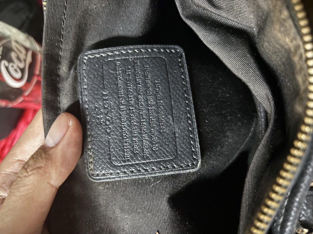Coach Brown Signature Handbag (Category: Luxury Bags & Wallets) located in Quezon City. Submitted by tarphouse (Listing ID 1424326459, Image 3). Description: Authentic Coach handbag with a brown signature pattern. Features a top zipper closure, dual top handles, and an adjustable shoulder strap. The interior includes a Coach label. The bag has a classic design with a combination of brown and black colors. It has a metal Coach logo on the front..