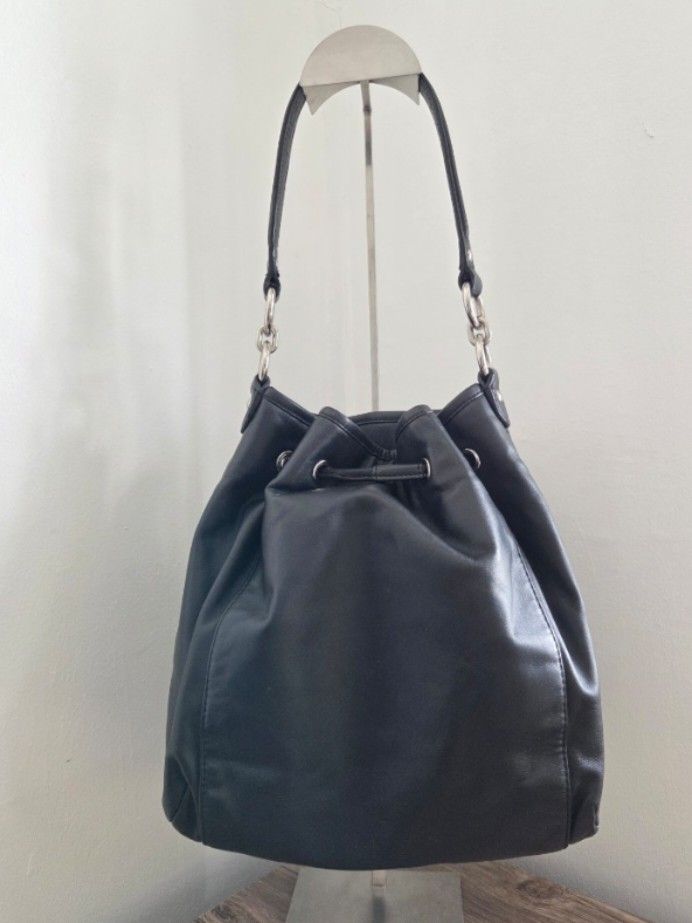 Coach Daisy Drawstring Handbag (Category: Luxury Bags & Wallets) located in General Trias. Submitted by ClutterCrunch (Listing ID 1424170099, Image 3). Description: - Authentic Coach handbag - Black leather - Drawstring closure - Front zippered pocket - Silver-tone hardware - Detachable shoulder strap - Fabric lining with multiple pockets - Coach leather story patch inside - Missing hang tag - Model number: F1361-F25661 Shipping c/o buyer, thru l