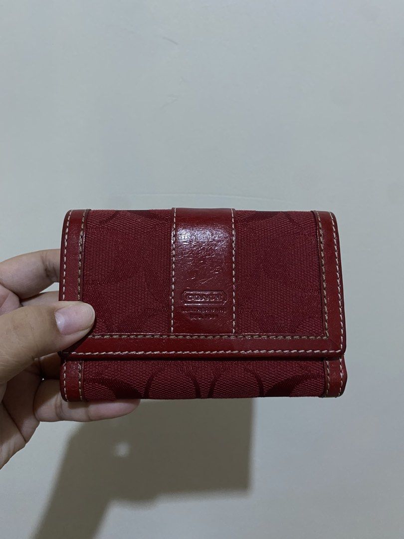 Coach Red Wallet (Category: Luxury Bags & Wallets) located in General Santos City (Dadiangas). Submitted by bagtobasics.ph_ (Listing ID 1424226645, Image 2). Description: - Authentic Coach wallet - Red with signature pattern - Multiple compartments for cards and cash - Snap closure - Leather exterior - Black fabric interior - Compact size.