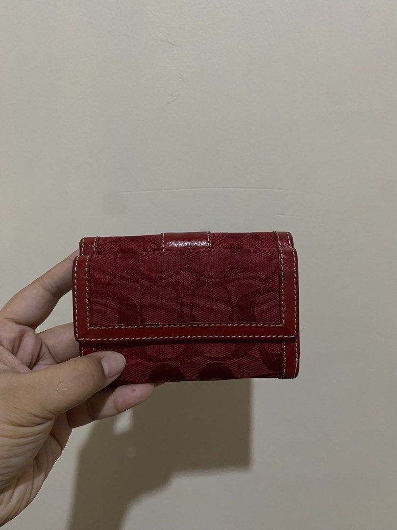 Coach Red Wallet (Category: Luxury Bags & Wallets) located in General Santos City (Dadiangas). Submitted by bagtobasics.ph_ (Listing ID 1424226645, Image 3). Description: - Authentic Coach wallet - Red with signature pattern - Multiple compartments for cards and cash - Snap closure - Leather exterior - Black fabric interior - Compact size.