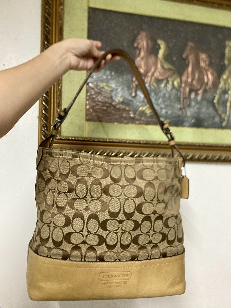 Coach Signature Shoulder/Hobo Bag (Category: Luxury Bags & Wallets) located in Quezon City. Submitted by philo.clutters (Listing ID 1424265374, Image 3). Description: - Authentic Coach shoulder bag - Signature print design - Tan leather base and straps - Fabric lined interior - Includes a small pocket - Comes with Coach hangtag - Fits a tablet/ipad. Very Spacious - Model: C0885-F12518 negotiable.