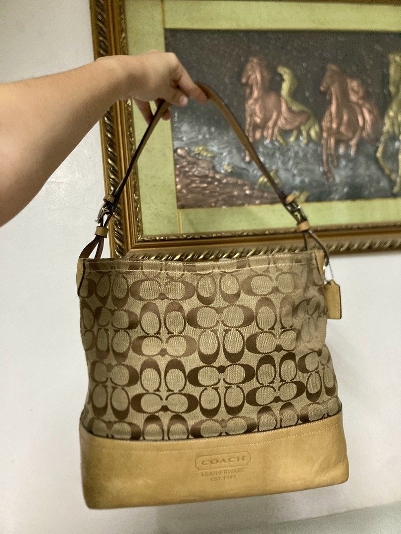 Coach Signature Shoulder/Hobo Bag (Category: Luxury Bags & Wallets) located in Quezon City. Submitted by philo.clutters (Listing ID 1424265374, Image 2). Description: - Authentic Coach shoulder bag - Signature print design - Tan leather base and straps - Fabric lined interior - Includes a small pocket - Comes with Coach hangtag - Fits a tablet/ipad. Very Spacious - Model: C0885-F12518 negotiable.