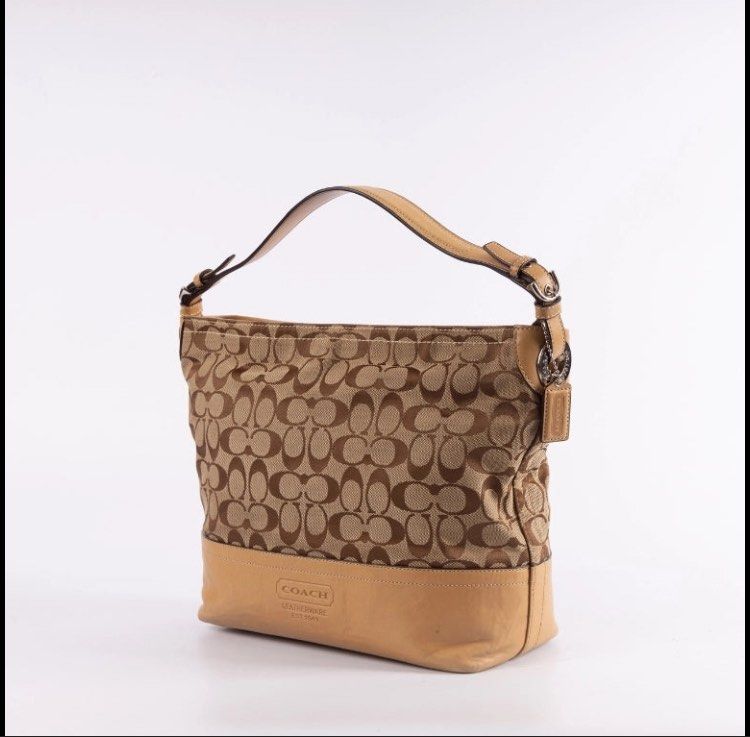 Coach Signature Shoulder/Hobo Bag (Category: Luxury Bags & Wallets) located in Quezon City. Submitted by philo.clutters (Listing ID 1424265374, Image 1). Description: - Authentic Coach shoulder bag - Signature print design - Tan leather base and straps - Fabric lined interior - Includes a small pocket - Comes with Coach hangtag - Fits a tablet/ipad. Very Spacious - Model: C0885-F12518 negotiable.