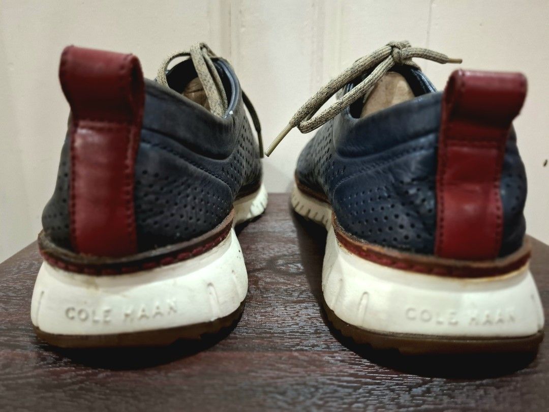 Cole Haan ZEROGRAND Perforated Leather Shoes (Category: Casual Shoes) located in Mandaluyong City. Submitted by redmgn (Listing ID 1424271121, Image 3). Description: - Cole Haan ZEROGRAND shoes - navy blue leather upper - White and brown soles - Lace-up closure - Red heel accent - "COLE HAAN" and "ZEROGRAND" sole markings.