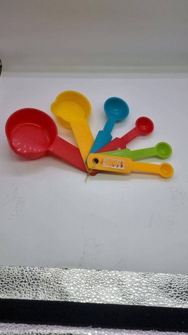 Colorful Measuring Cups and Spoons Set (Category: Other Kitchenware & Tableware) located in Marikina City. Submitted by andreah_16 (Listing ID 1424338254, Image 1). Description: - Complete measuring cup and spoon set. - Made of durable, colorful plastic. - Includes various sizes for all your cooking and baking needs. - Conveniently attached with a ring for organized storage. - Perfect for both beginner and experienced cooks!.