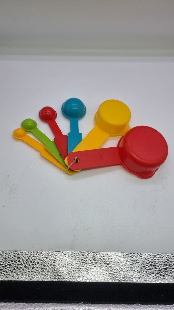 Colorful Measuring Cups and Spoons Set (Category: Other Kitchenware & Tableware) located in Marikina City. Submitted by andreah_16 (Listing ID 1424338254, Image 2). Description: - Complete measuring cup and spoon set. - Made of durable, colorful plastic. - Includes various sizes for all your cooking and baking needs. - Conveniently attached with a ring for organized storage. - Perfect for both beginner and experienced cooks!.