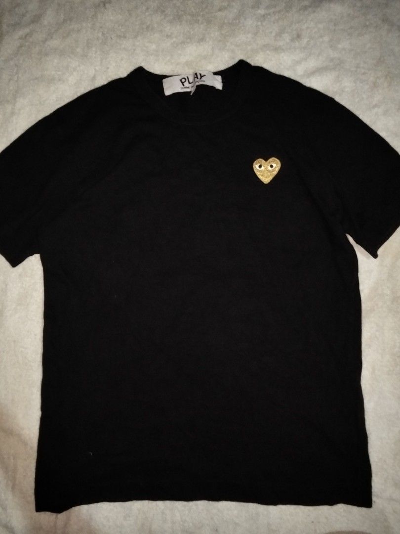 Comme des Garcons Play Gold Heart T-shirt (Category: Shirts) located in General Santos City (Dadiangas). Submitted by angelofetr74296 (Listing ID 1424278330, Image 2). Description: - Black Comme des Garcons Play T-shirt - Features a gold heart logo - Crew neck and short sleeves - Size: S - Made in Japan - Material: 100% cotton.