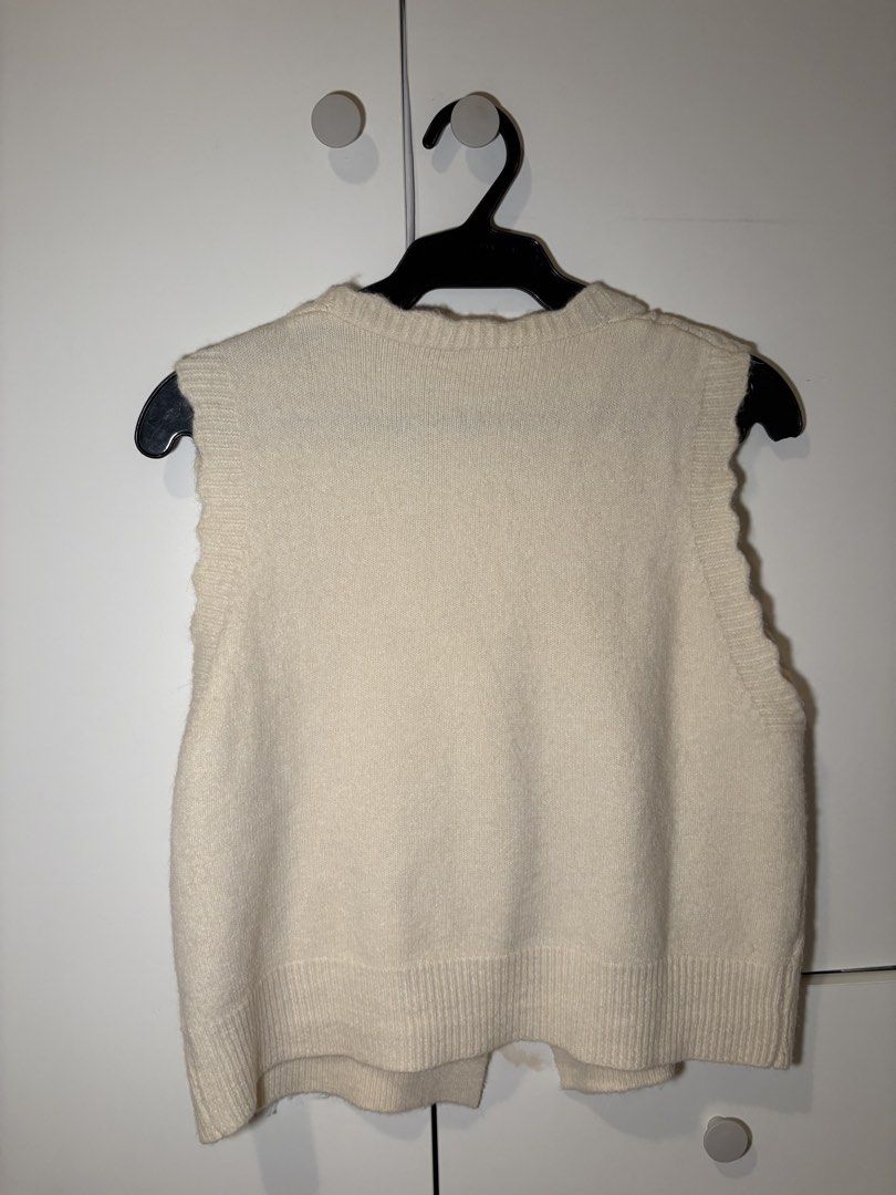 Cream-colored Knitted Vest with Bows (Category: Sleeveless) located in Paranaque City. Submitted by 12345coconuts (Listing ID 1424274186, Image 2). Description: Very dainty and cute vest!! Goes well with blouses and dresses RFS: Barely used, decluttering MOP: GCash/GoThyme/ QR Ph Please manage expectations as this is a preloved item! .