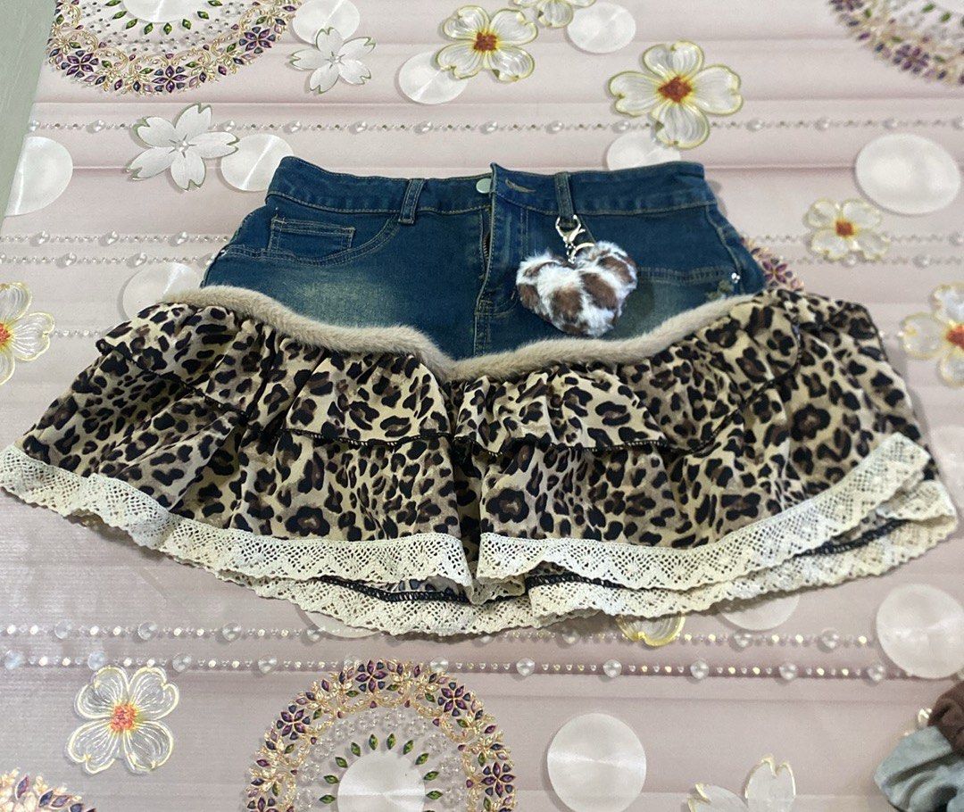 Denim Leopard Print Skirt (Category: Skirts) located in Manila. Submitted by fiercefleur (Listing ID 1424219201, Image 1). Description: - Denim waistband - Leopard print ruffle design - Lace trim at the bottom - Includes a heart-shaped keychain - Unique and stylish.