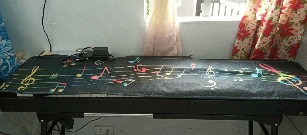 Digital Piano with Music Sheet Cover (Category: Musical Instruments) located in Makati City. Submitted by livefire.73dc34 (Listing ID 1424182883, Image 2). Description: - Full-size digital piano - Features a digital display and control buttons - Includes music sheet cover - Comes with a power adapter - Keys are black and white.