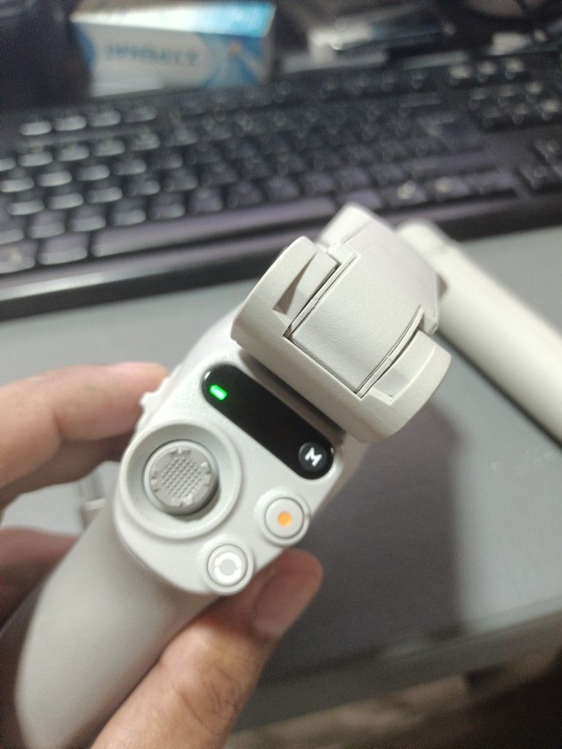 DJI OM 4 Smartphone Gimbal Stabilizer (Category: Gimbals & Stabilizers ) located in Pasig City. Submitted by Mpatron (Listing ID 1424236562, Image 2). Description: - DJI OM 4 Smartphone Gimbal - Foldable design for portability - Magnetic phone clamp for quick setup - Intuitive control panel - Features the DJI logo - Stylish white/gray color.