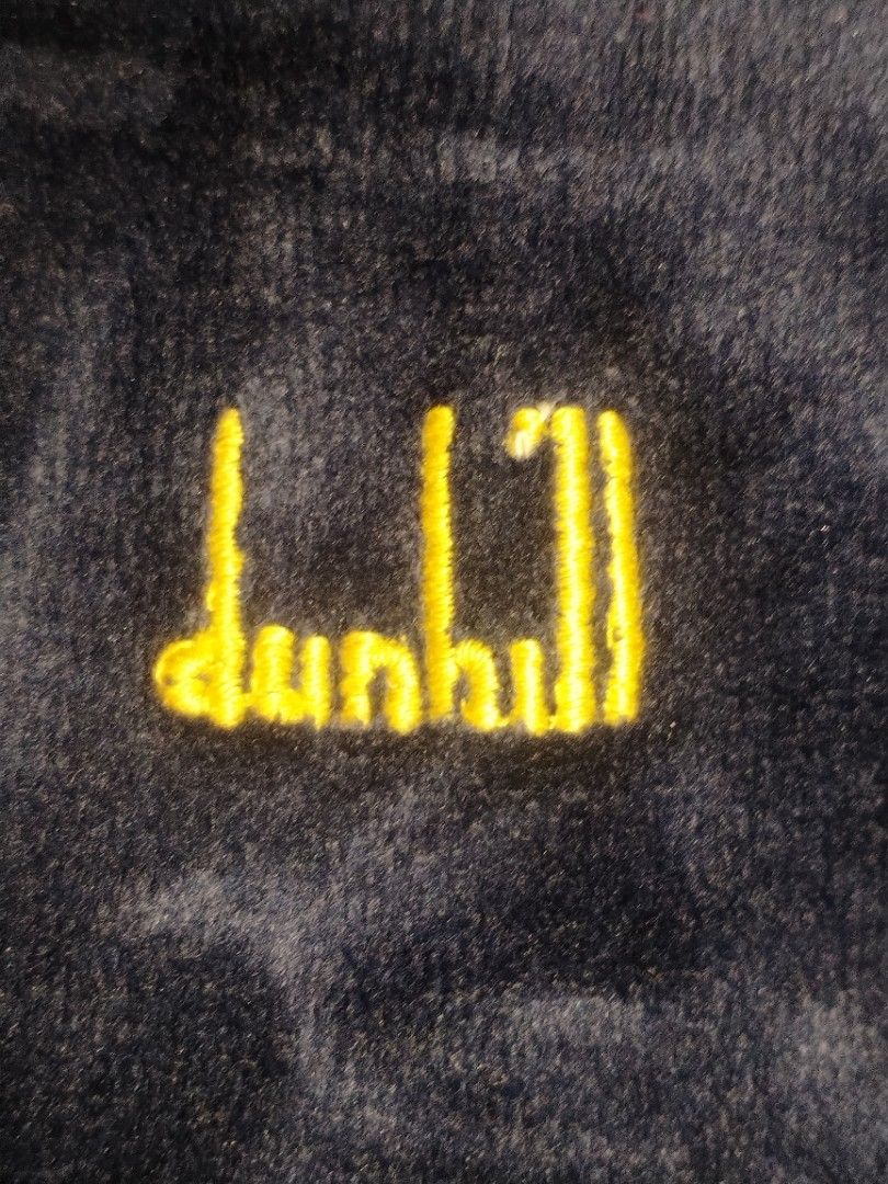 Dunhill London Velvet Jacket (Category: Coats, Jackets and Outerwear) located in Baguio. Submitted by luxeloom099 (Listing ID 1424337510, Image 2). Description: Navy blue velvet jacket from Dunhill London. Features a gold zipper and the Dunhill logo embroidered on the chest. The label indicates it's made in Switzerland with a blend of cotton and polyamide. Ribbed collar and cuffs. A stylish and classic piece. 26l x 20w.