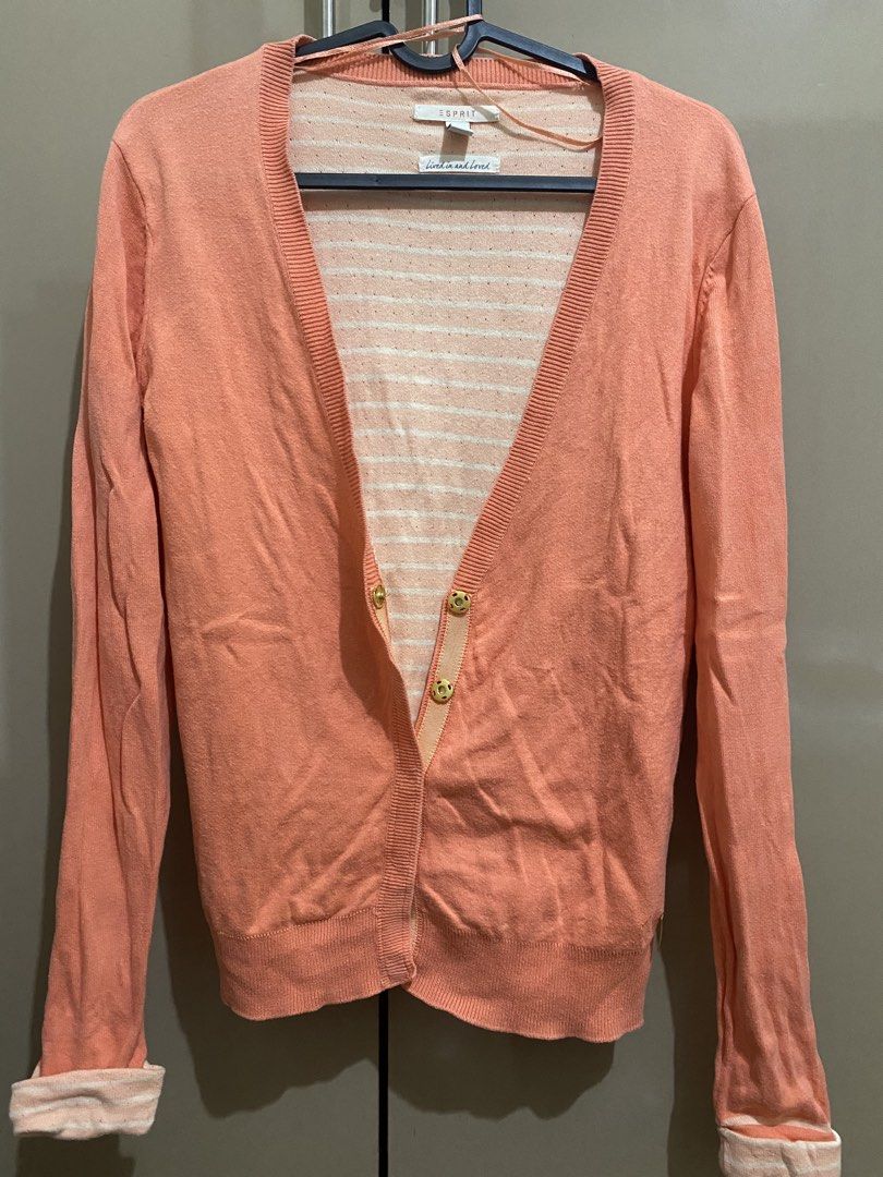 Esprit Peach Cardigan (Category: Coats, Jackets and Outerwear) located in Taguig. Submitted by jaebae_ (Listing ID 1424325167, Image 1). Description: - Esprit cardigan - Peach color - V-neck design - can fit to S-M - Long sleeves with folded cuffs - Gold Button closures - Striped interior lining - Brand tag visible.