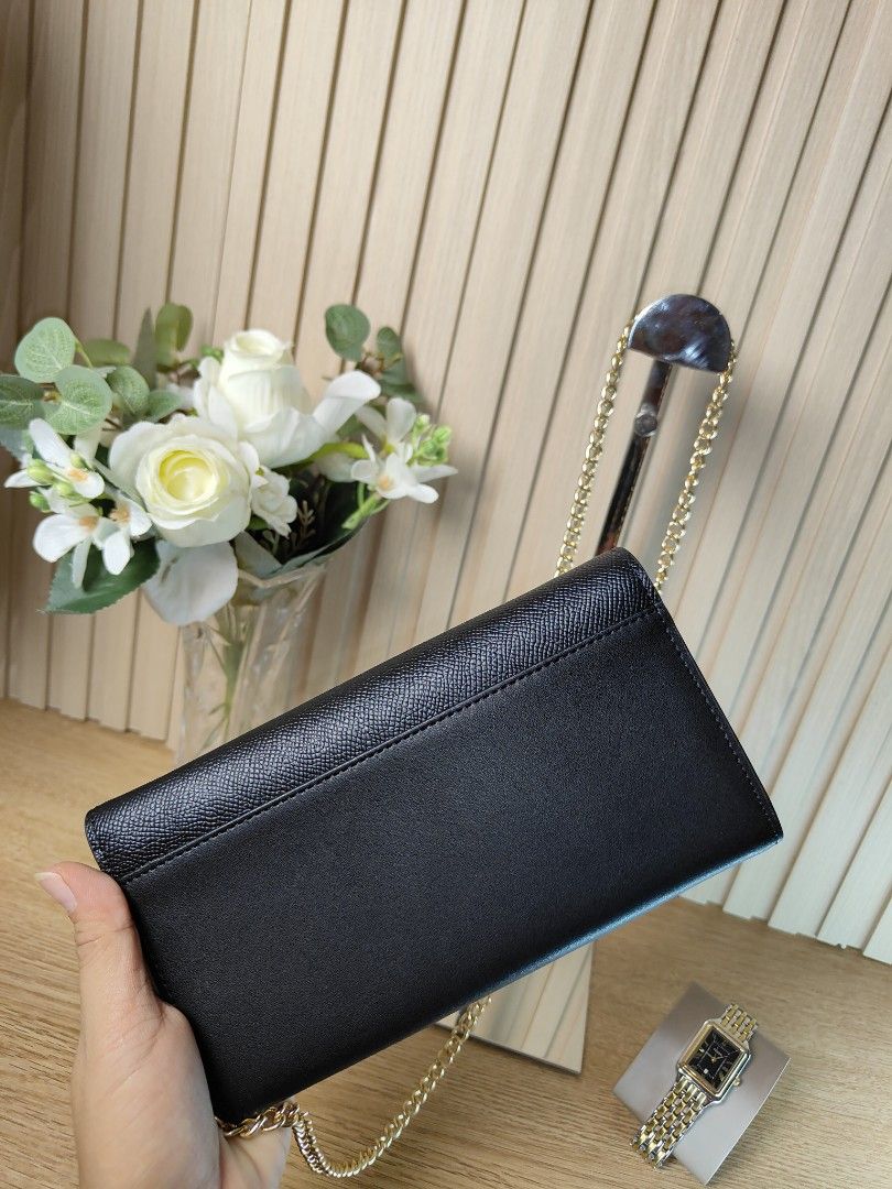 Fendi Chain Wallet Black (Category: Luxury Bags & Wallets) located in Naga. Submitted by demaria14 (Listing ID 1424323245, Image 2). Description: Black Fendi chain wallet with gold-tone hardware. Features a chain strap, a flap closure with a gold-tone logo, and multiple interior compartments. Includes a yellow authenticity card. The interior has multiple card slots and a zippered pocket..