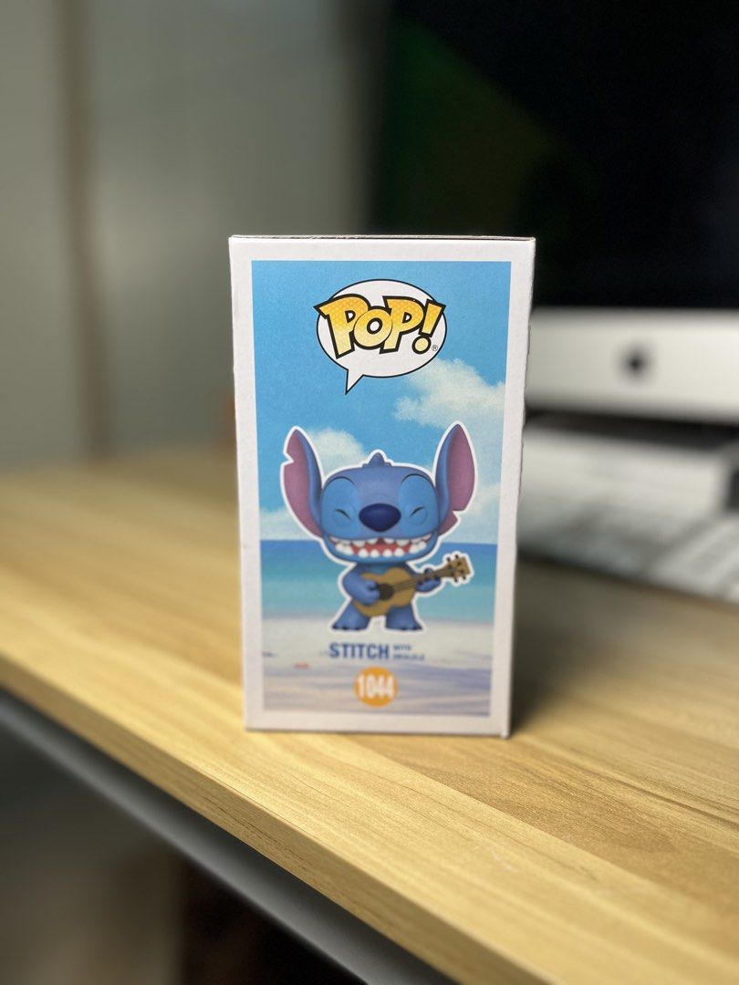 Funko Pop! Disney Lilo & Stitch with Ukulele #1044 (Category: Designer & Blind Box Toys) located in Dasmarinas. Submitted by margo09 (Listing ID 1424182052, Image 3). Description: Funko Pop! figure features Stitch from Disney's Lilo & Stitch, playing a ukulele. The figure is number 1044 in the series. The box shows Stitch on a beach background. The back of the box displays other figures from the collection. It is a collectible item for Disney fan