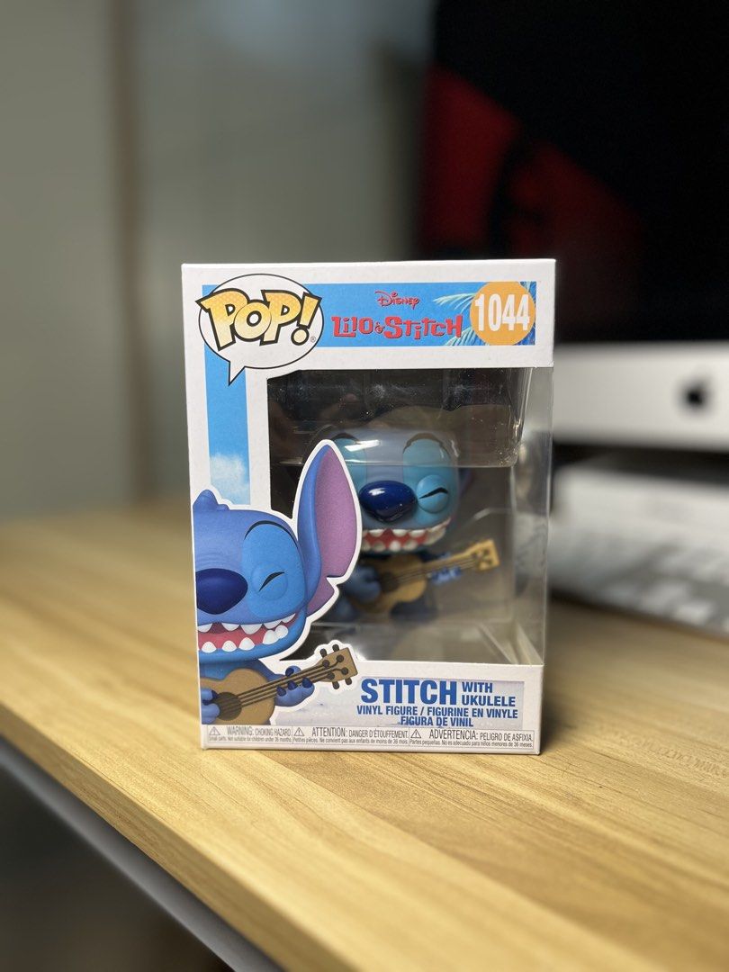 Funko Pop! Disney Lilo & Stitch with Ukulele #1044 (Category: Designer & Blind Box Toys) located in Dasmarinas. Submitted by margo09 (Listing ID 1424182052, Image 1). Description: Funko Pop! figure features Stitch from Disney's Lilo & Stitch, playing a ukulele. The figure is number 1044 in the series. The box shows Stitch on a beach background. The back of the box displays other figures from the collection. It is a collectible item for Disney fan