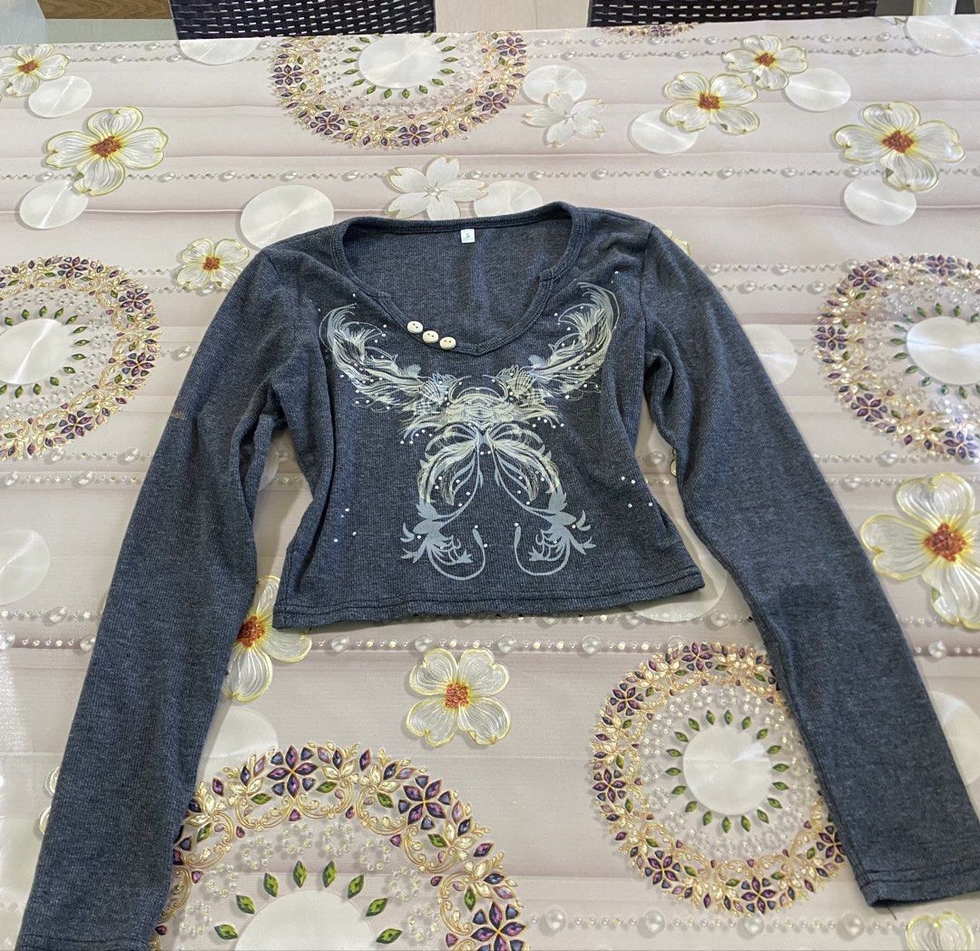 Gray Long Sleeve Top with Embellishments (Category: Longsleeves) located in Manila. Submitted by fiercefleur (Listing ID 1424226738, Image 1). Description: - Gray long-sleeved top - Scoop neckline - Decorative embellishments on front - Three small buttons - Cropped fit - Soft material.