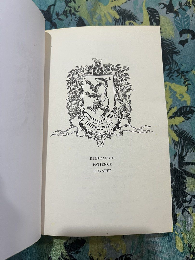 Harry Potter and the Philosopher's Stone Hufflepuff Edition (Category: Storybooks) located in Gapan. Submitted by booknest (Listing ID 1424172640, Image 1). Description: - Harry Potter and the Philosopher's Stone: Hufflepuff Edition - Features a sleek black cover with elegant gold lettering. - Page edges are uniquely designed with yellow and black stripes. - Includes the Hufflepuff crest inside. - Written by J.K. Rowling. No dust jacket , waterma