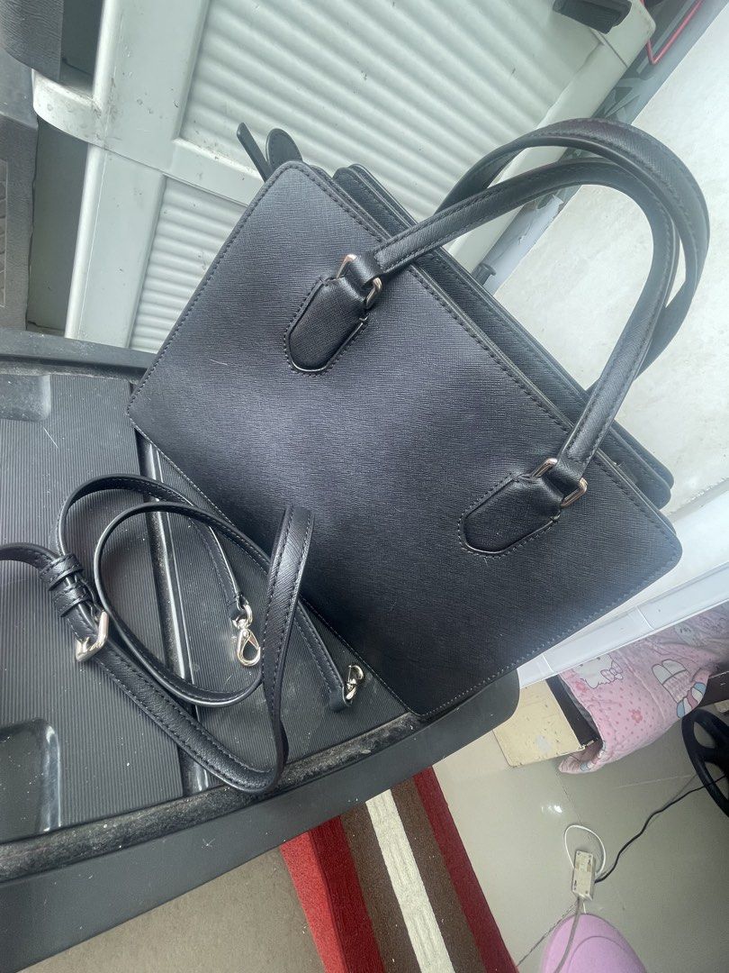 Kate Spade Black Satchel Handbag (Category: Luxury Bags & Wallets) located in Paranaque City. Submitted by maryyyyy21 (Listing ID 1424176943, Image 3). Description: - Authentic Kate Spade satchel handbag - Top handle and detachable shoulder strap - Includes care card - Interior: patterned lining, multiple compartments - Closure: Magnetic - Exterior: Textured material - Features Kate Spade logo - original price 14k.