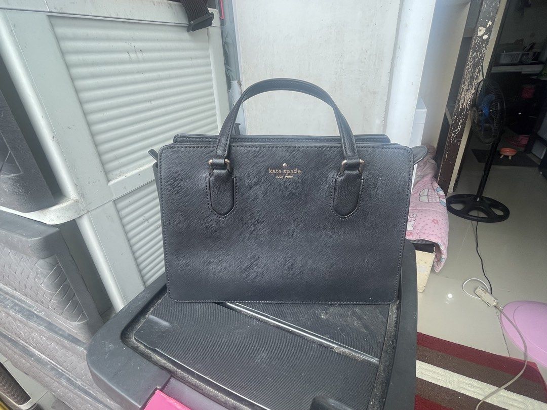 Kate Spade Black Satchel Handbag (Category: Luxury Bags & Wallets) located in Paranaque City. Submitted by maryyyyy21 (Listing ID 1424176943, Image 2). Description: - Authentic Kate Spade satchel handbag - Top handle and detachable shoulder strap - Includes care card - Interior: patterned lining, multiple compartments - Closure: Magnetic - Exterior: Textured material - Features Kate Spade logo - original price 14k.