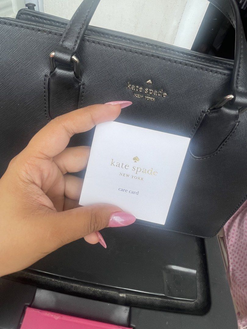Kate Spade Black Satchel Handbag (Category: Luxury Bags & Wallets) located in Paranaque City. Submitted by maryyyyy21 (Listing ID 1424176943, Image 1). Description: - Authentic Kate Spade satchel handbag - Top handle and detachable shoulder strap - Includes care card - Interior: patterned lining, multiple compartments - Closure: Magnetic - Exterior: Textured material - Features Kate Spade logo - original price 14k.