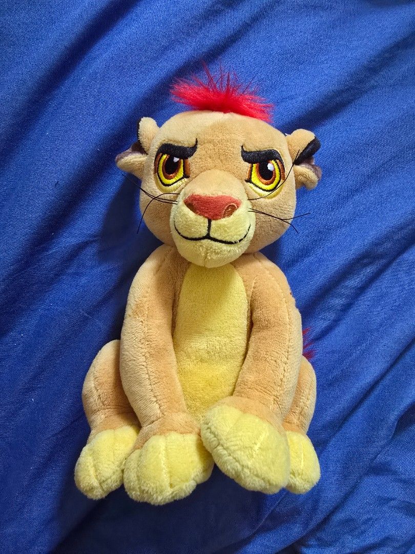 KION - Lion King Plush Toy (Category: Plushies & Soft Toys) located in Manila. Submitted by jamyla (Listing ID 1424211006, Image 1). Description: - Cute lion cub plush toy - Features a vibrant red mane - Soft tan body and yellow paws - Detailed facial features including whiskers and large eyes - Perfect for cuddling! - Resting on a blue surface.