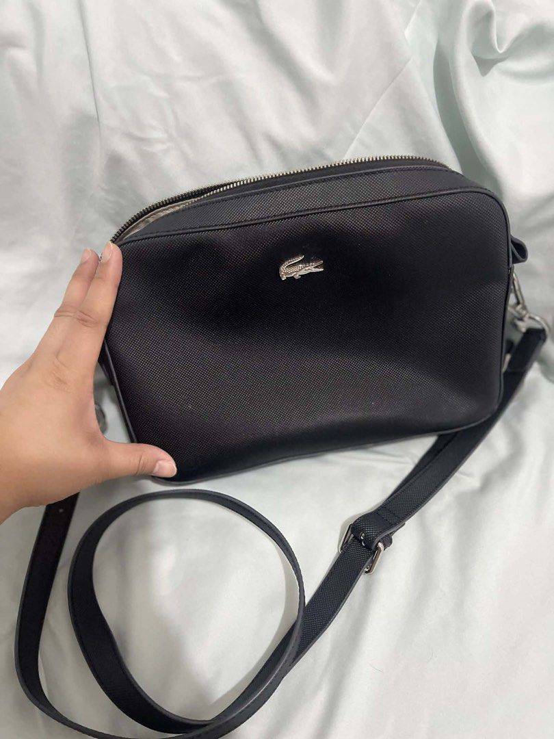 Lacoste Black Crossbody Bag (Category: Cross-body Bags) located in Cabanatuan. Submitted by krnlim (Listing ID 1420578831, Image 3). Description: - Black Lacoste crossbody bag - Rectangular shape - Silver Lacoste logo - Adjustable long strap - Silver hardware - Textured exterior - Ideal for daily use.