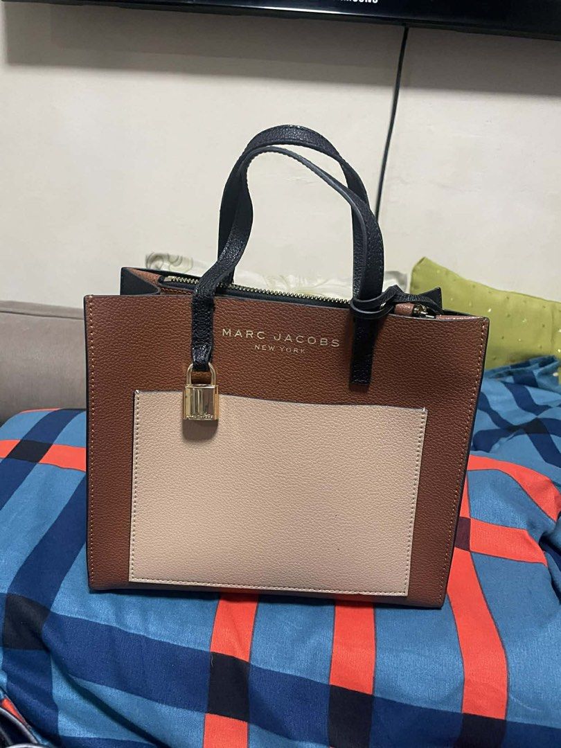 Marc Jacobs New York Handbag (Category: Luxury Bags & Wallets) located in Cavite. Submitted by sleigh21 (Listing ID 1424183572, Image 1). Description: - Marc Jacobs handbag - Color block design: brown, black, beige - Top handle - Zip closure - Gold-tone lock detail - Detachable strap - Approximately 8 inches in height - Great for everyday use.