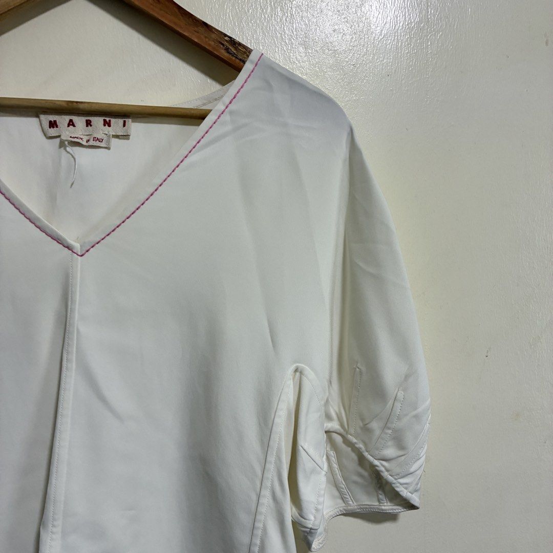MARNI White V-Neck Top (Category: Sleeveless) located in Cabuyao City. Submitted by fffrag (Listing ID 1424207057, Image 2). Description: - MARNI top - V-neck design - Pink stitching details - Short, puffy sleeves - Made in Italy - Size 40 - White color - Lightweight fabric.