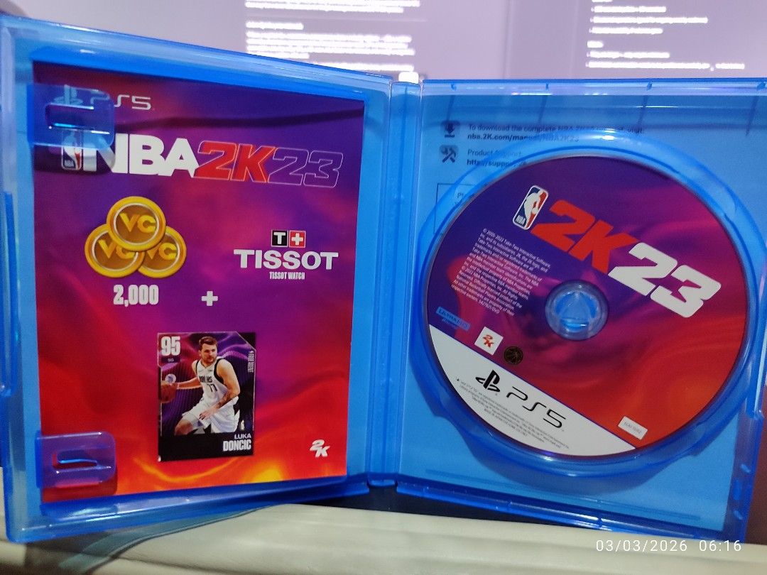 NBA 2K23 - PS5 (Category: PlayStation) located in Taguig. Submitted by mary6038 (Listing ID 1424336071, Image 2). Description: NBA 2K23 for PlayStation 5. Includes the game disc, a bonus card, and VC (Virtual Currency) codes. The game case is blue. The game features Devin Booker on the cover. Includes Tissot Tour Bonus..