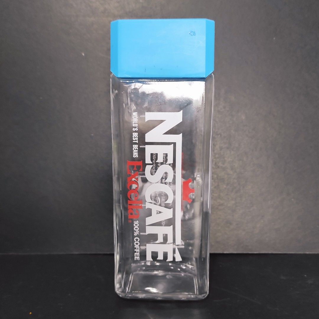 Nescafe Excella Glass Bottle (Category: Water Bottles & Tumblers) located in Cainta. Submitted by fukunekojapansurplus (Listing ID 1424206639, Image 1). Description: 200 pesos no issue Nescafe Excella glass bottle - Blue cap - Rectangular shape - Dimensions: Approximately 10cm (length) x 4cm (width) - Clear bottle - Features Nescafe logo and "World's Best Beans" print ✨ A quick Yes or No after inquiry is appreciated ✨ 📍 Mayfield Park Residences 