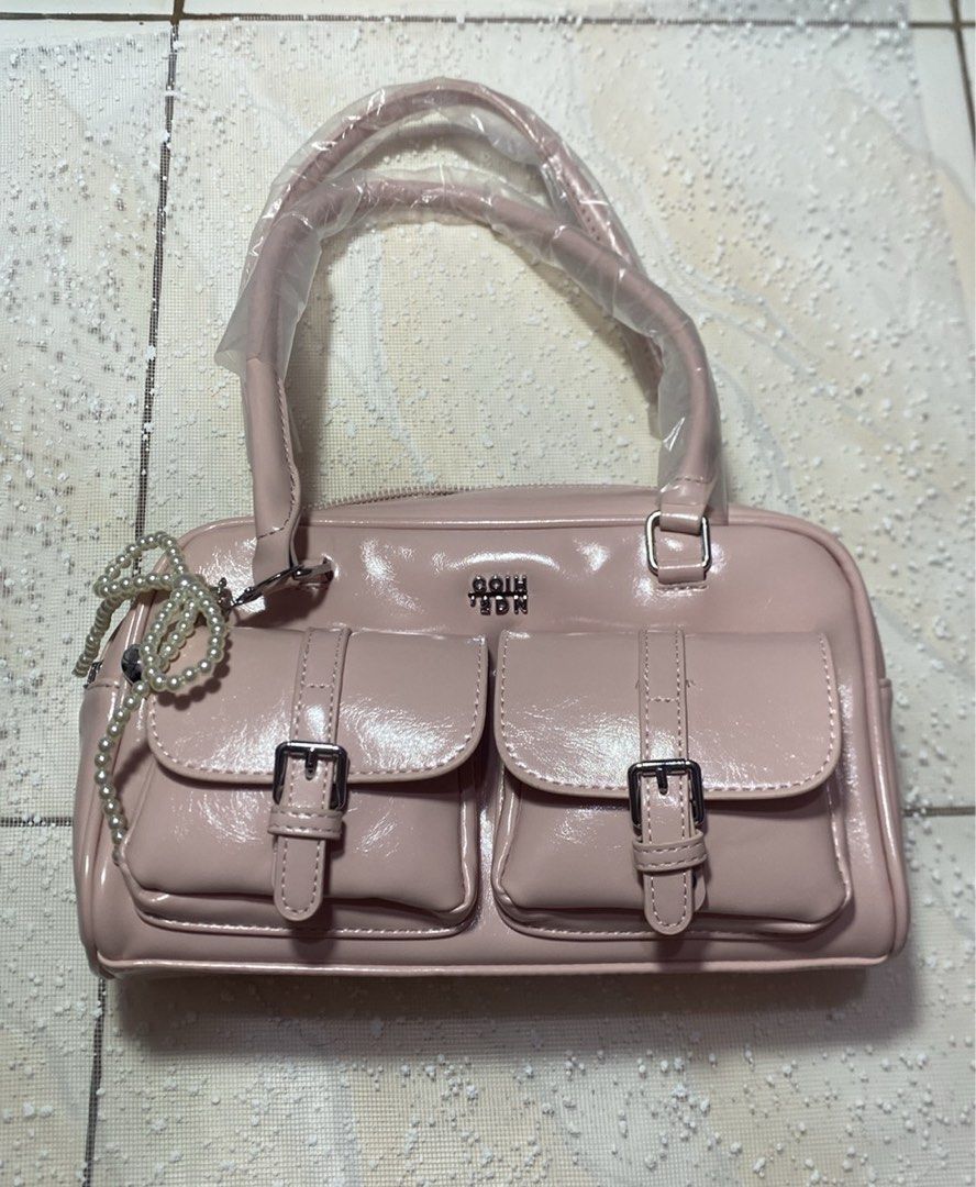 Pink Handbag with Buckle Pockets (Category: Shoulder Bags) located in Manila. Submitted by fiercefleur (Listing ID 1424226965, Image 1). Description: - Pink MGR handbag - Glossy finish - Two front pockets with buckle closures - Top handle - Zipper closure - Includes decorative pearl necklace.