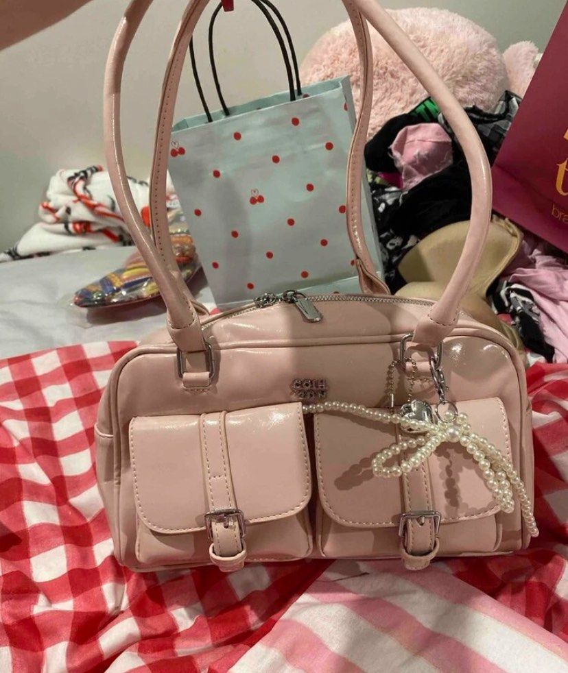 Pink Patent Leather Handbag (Category: Luxury Bags & Wallets) located in Manila. Submitted by fiercefleur (Listing ID 1424227051, Image 1). Description: - Pink patent leather handbag - Shoulder bag style - Two front pockets with buckle closures - Top zipper closure - Two handles - Includes a pearl charm.