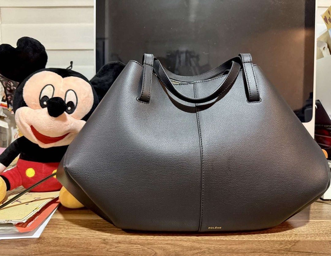 Polène Cyme Large (Category: Luxury Bags & Wallets) located in Pasig City. Submitted by jst.kth (Listing ID 1424286012, Image 2). Description: - Polène tote bag - Structured design - Features two top handles - Spacious interior - Solid Black color exterior - Made of textured leather - Perfect for everyday use - Versatile accessory Rfs: not being used .
