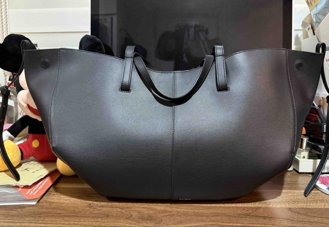 Polène Cyme Large (Category: Luxury Bags & Wallets) located in Pasig City. Submitted by jst.kth (Listing ID 1424286012, Image 1). Description: - Polène tote bag - Structured design - Features two top handles - Spacious interior - Solid Black color exterior - Made of textured leather - Perfect for everyday use - Versatile accessory Rfs: not being used .