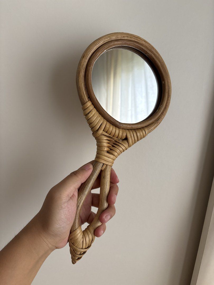 Rattan Handheld Mirror (Category: Mirrors) located in Imus. Submitted by _declutterby (Listing ID 1424198022, Image 1). Description: - Round mirror with woven rattan frame - Rattan handle for comfortable grip - Neutral color, versatile for any decor - Ideal for vanity or touch-ups.