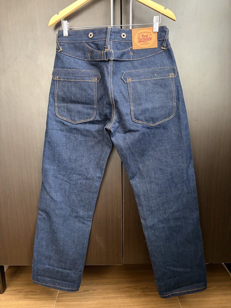 Red Tornado Buckle Back Blacksmith Selvedge Jeans (Category: Jeans) located in Urdaneta. Submitted by theoldmanstore (Listing ID 1424201455, Image 2). Description: Red Tornado selvedge jeans. Features a button fly, unique pocket design, and a belt loop detail at the back. The jeans have a dark blue wash with orange stitching. The size is W30 L30. Made in China. The jeans have a classic, vintage-inspired look..