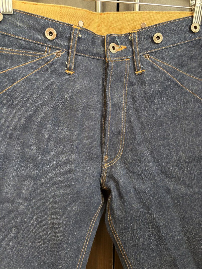 Red Tornado Buckle Back Blacksmith Selvedge Jeans (Category: Jeans) located in Urdaneta. Submitted by theoldmanstore (Listing ID 1424201455, Image 3). Description: Red Tornado selvedge jeans. Features a button fly, unique pocket design, and a belt loop detail at the back. The jeans have a dark blue wash with orange stitching. The size is W30 L30. Made in China. The jeans have a classic, vintage-inspired look..