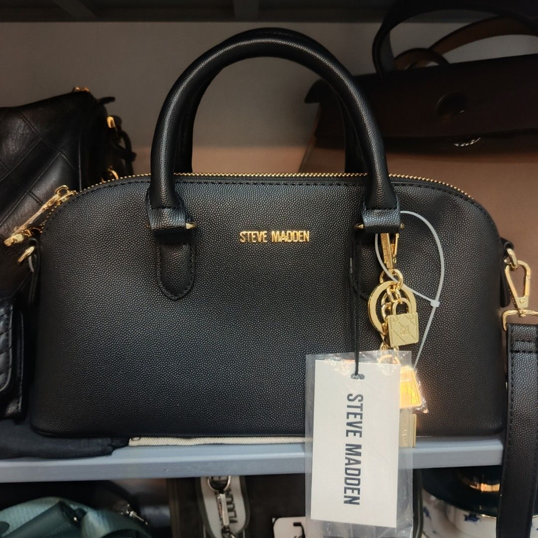 Steve Madden Galaxy Blue Dome Bag (Category: Cross-body Bags) located in Dagupan City. Submitted by nmcmp4 (Listing ID 1424237828, Image 1). Description: - Steve Madden dome bag - Color: Black - Hardware: Gold-tone - Features: Top handle, detachable shoulder strap - Details: Charm with mini bag and lock - No box - Closure: Zip - Model: "Galaxy Blue" - Original Price: $88.00.
