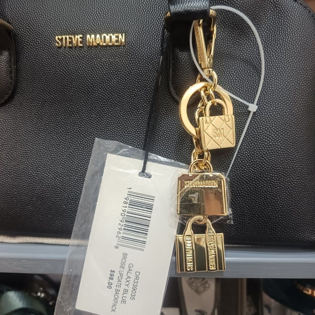 Steve Madden Galaxy Blue Dome Bag (Category: Cross-body Bags) located in Dagupan City. Submitted by nmcmp4 (Listing ID 1424237828, Image 2). Description: - Steve Madden dome bag - Color: Black - Hardware: Gold-tone - Features: Top handle, detachable shoulder strap - Details: Charm with mini bag and lock - No box - Closure: Zip - Model: "Galaxy Blue" - Original Price: $88.00.