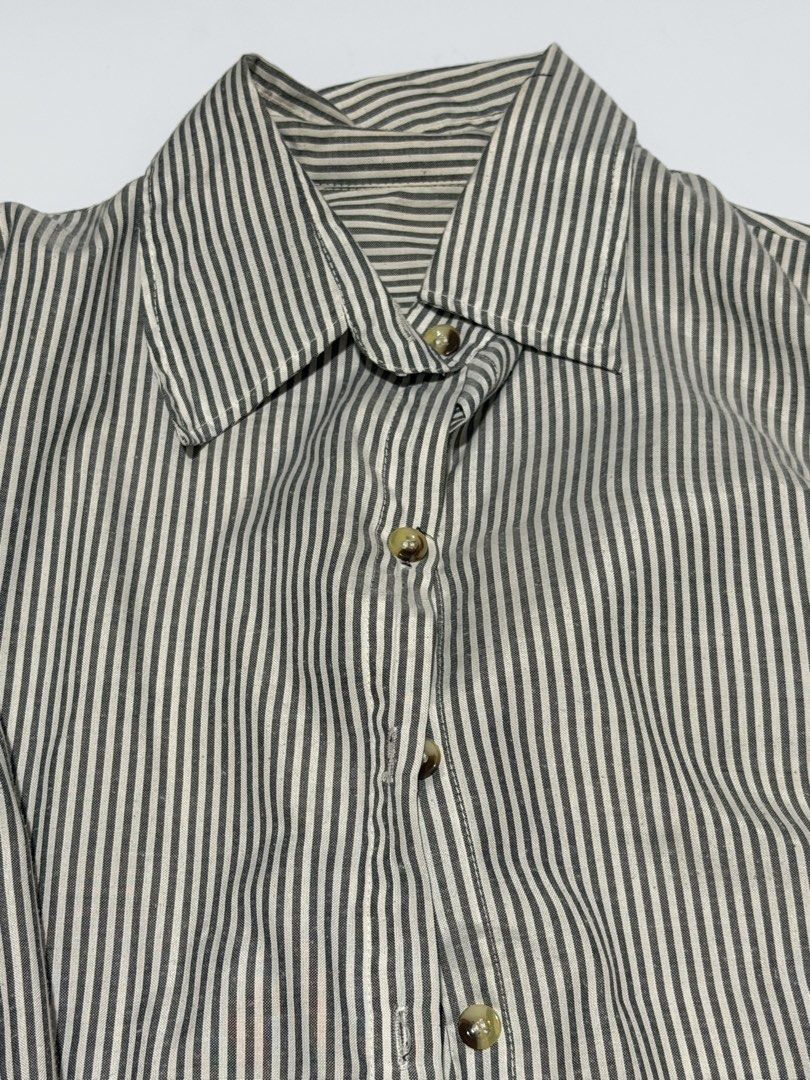 Striped Long Sleeve Shirt (Category: Tshirts & Polo Shirts ) located in Caloocan City. Submitted by _mitsuki (Listing ID 1424183252, Image 2). Description: ‼️ DECLUTTERING ‼️ Model Height: 5'6 Model Weight: 69.5kg Classic long-sleeved shirt with vertical stripes. Features a collared neckline and button-down closure. The sleeves have a buttoned cuff and a buttoned tab for rolling up. The shirt has a relaxed fit, suitable for casual wear. MOP: Unio